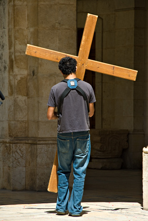 Carrying his cross.